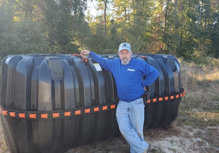 Tony Cambell, owner beside a backflow device